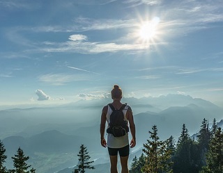 Hiker looking at a motivational sunset