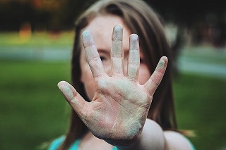 Shy woman holding hand up saying no